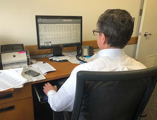 A Dane County employee looks at a spreadsheet